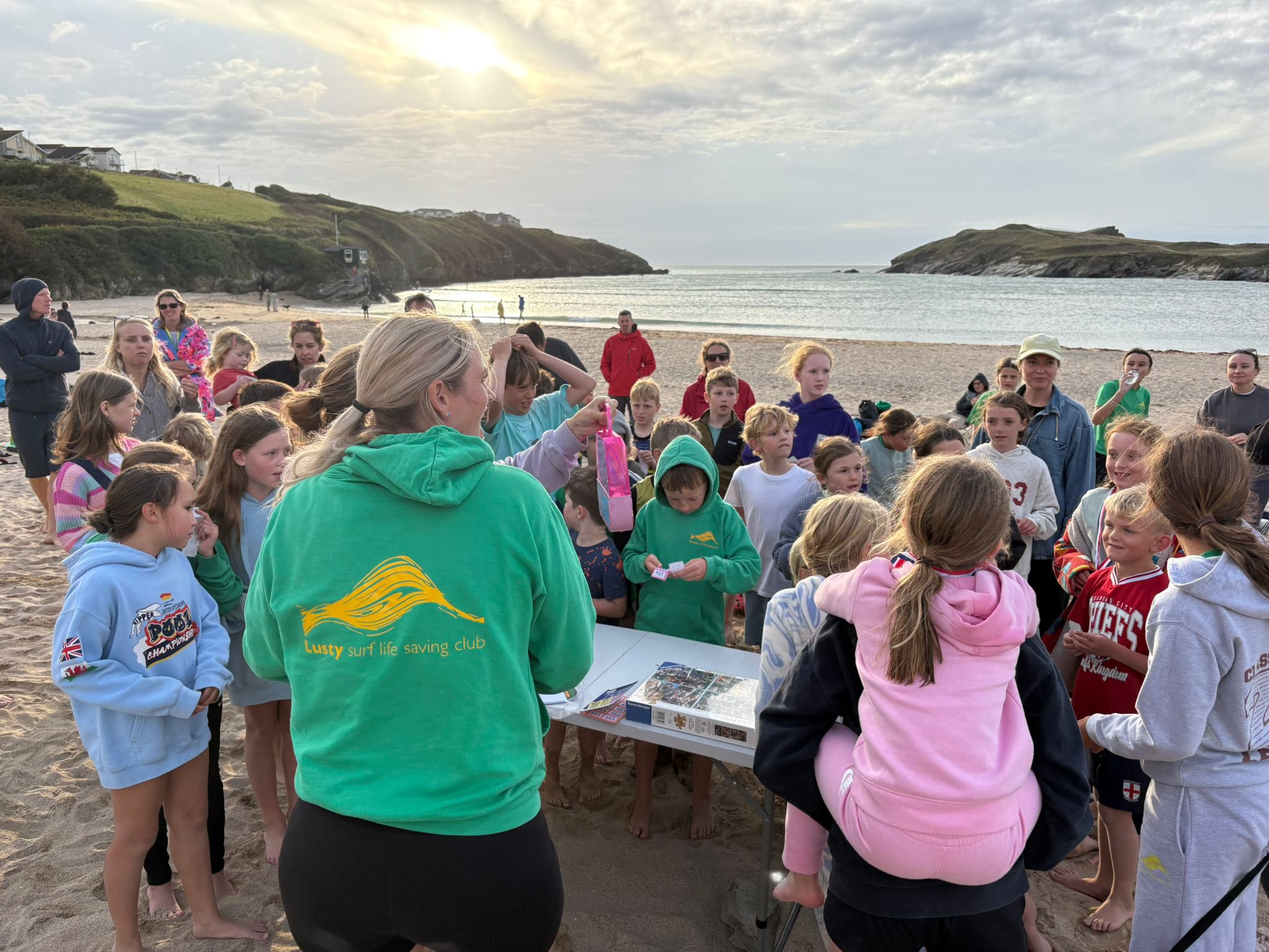 May be an image of 4 people, elephant seal, ocean, crowd and text